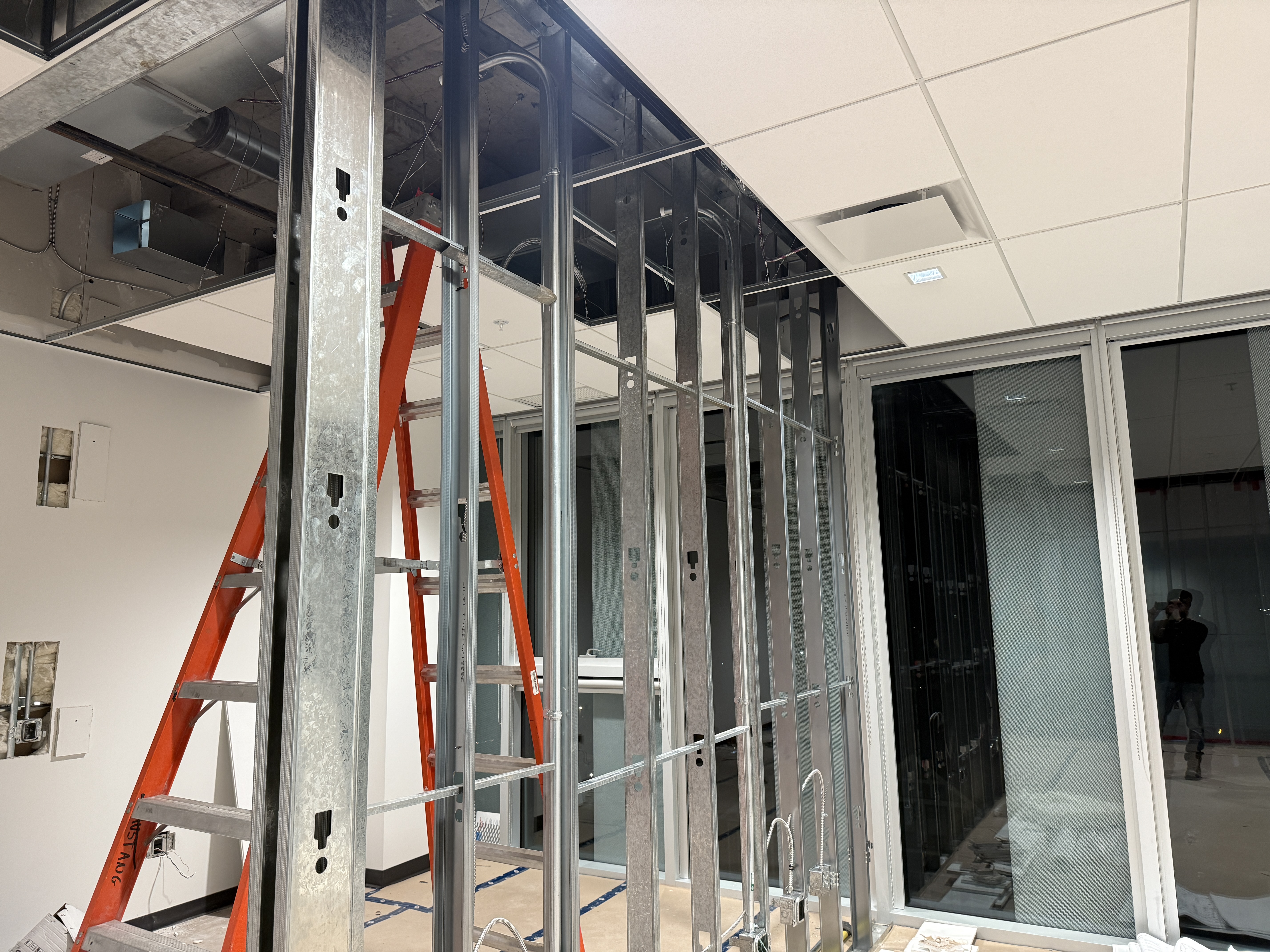 Steel framing prepared for interior glazing at a Surrey renovation