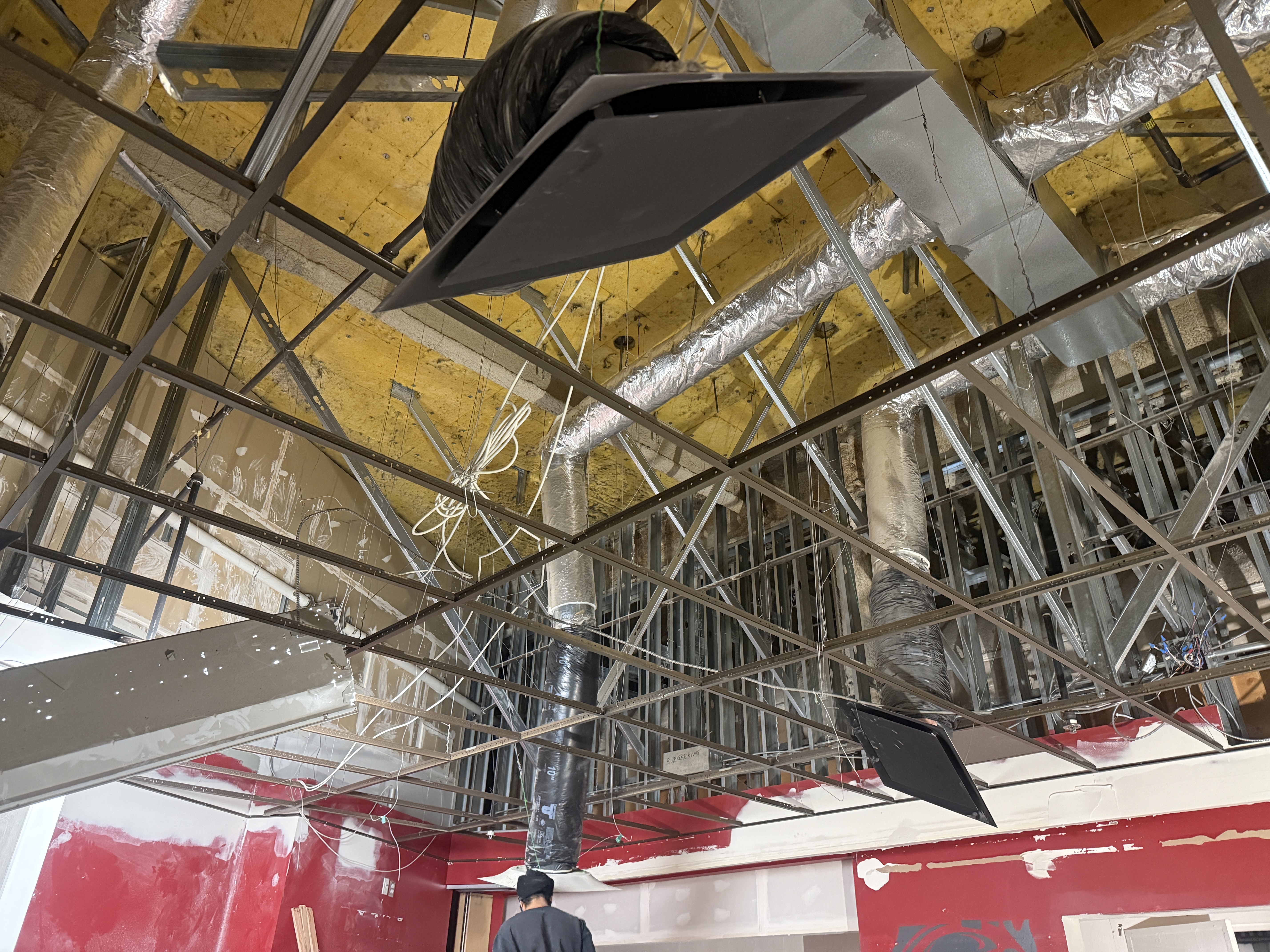 Black suspended T-bar grid installed in a Surrey restaurant tenant improvement
