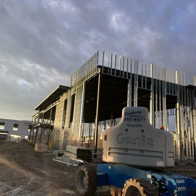 Multi-storey commercial building with exterior steel stud framing in progress
