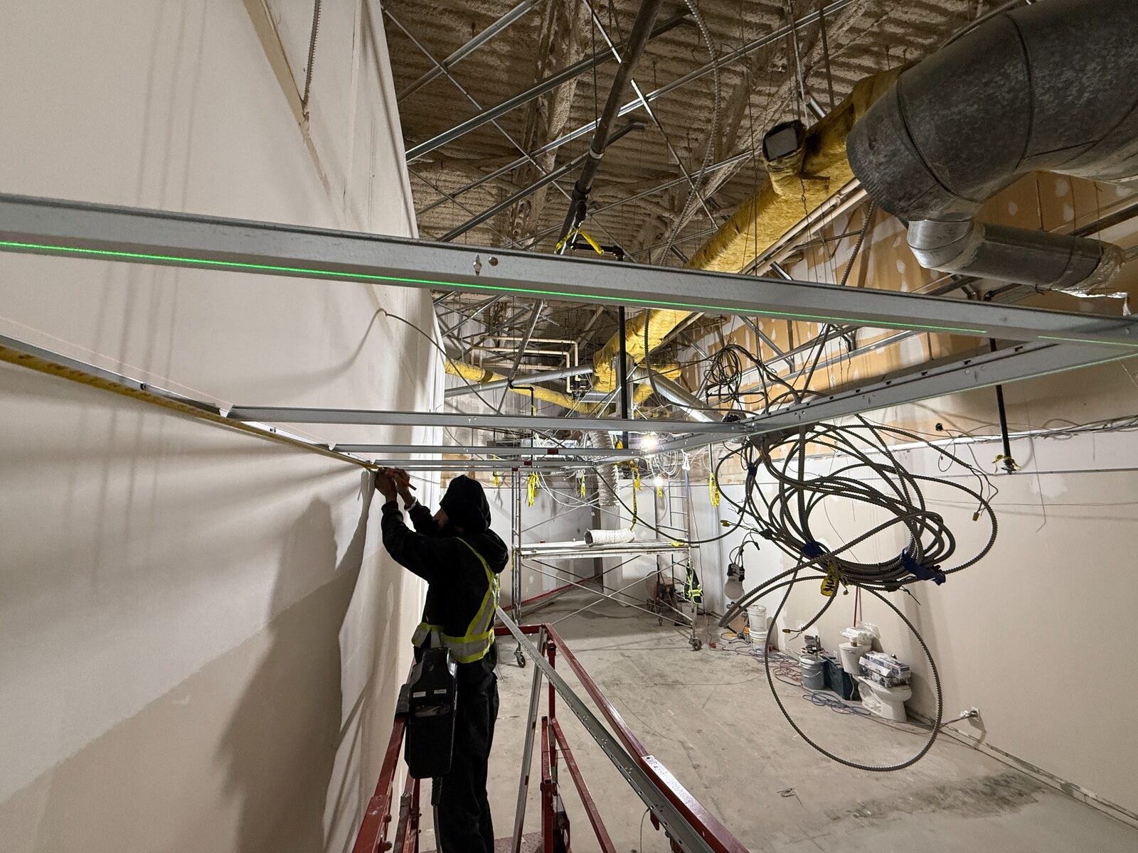 Suspended T-Bar ceiling grid being installed in a commercial interior